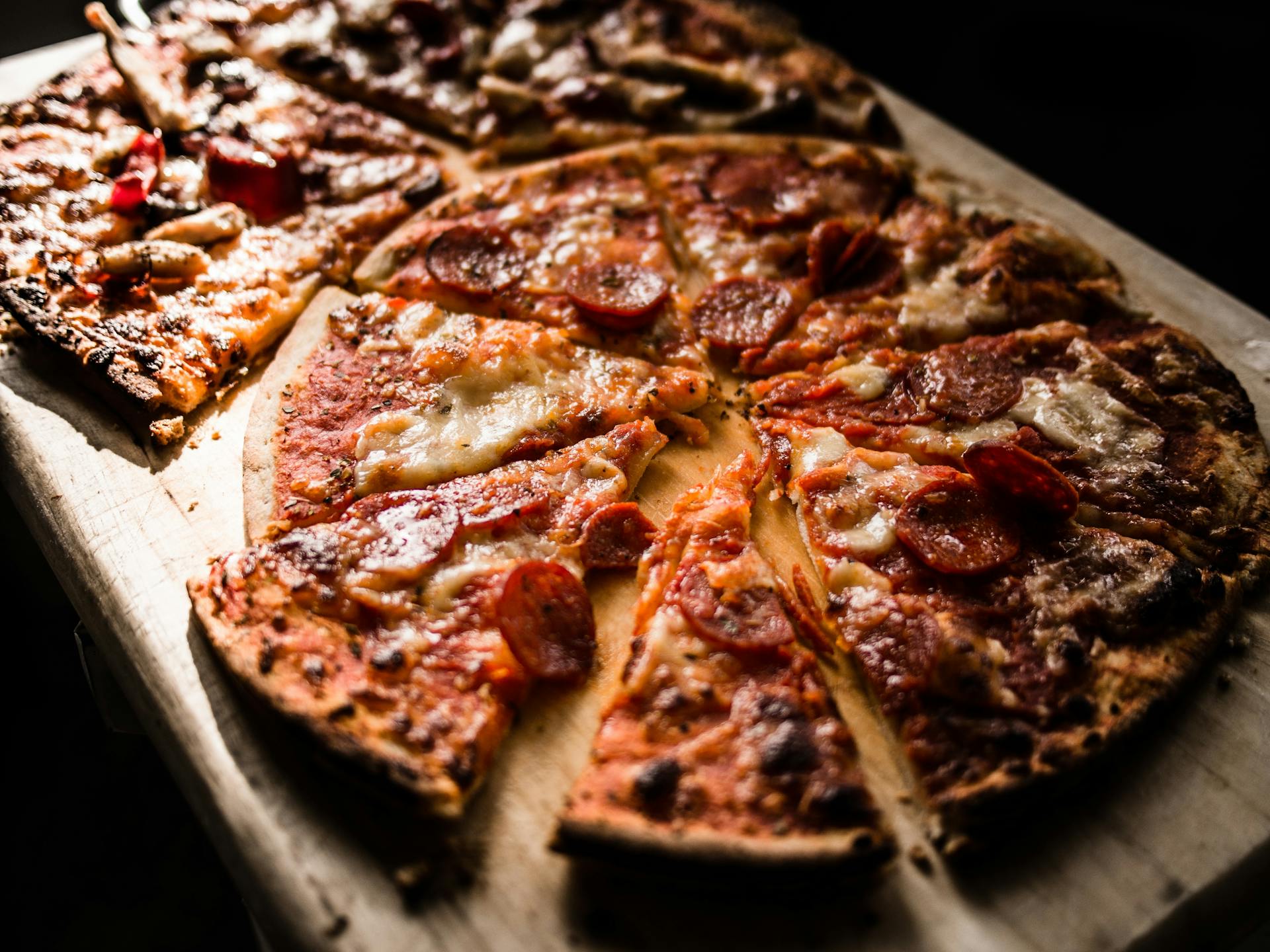 a slice of pizza sitting on top of a cutting board