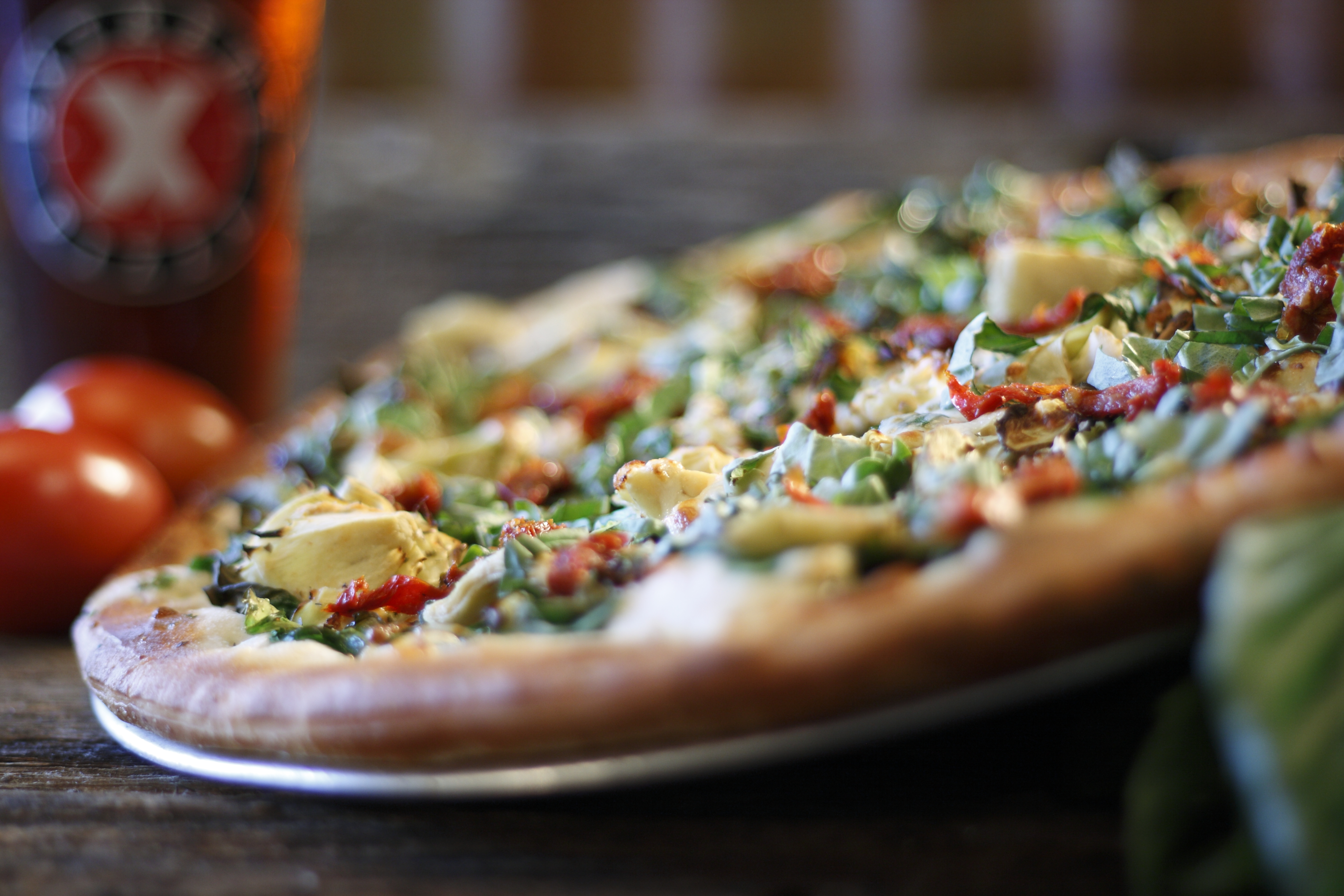 a pizza sitting on top of a wooden table