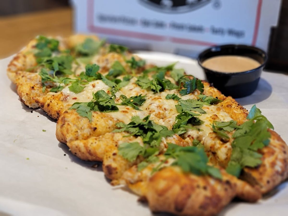 a plate of food with a slice of pizza