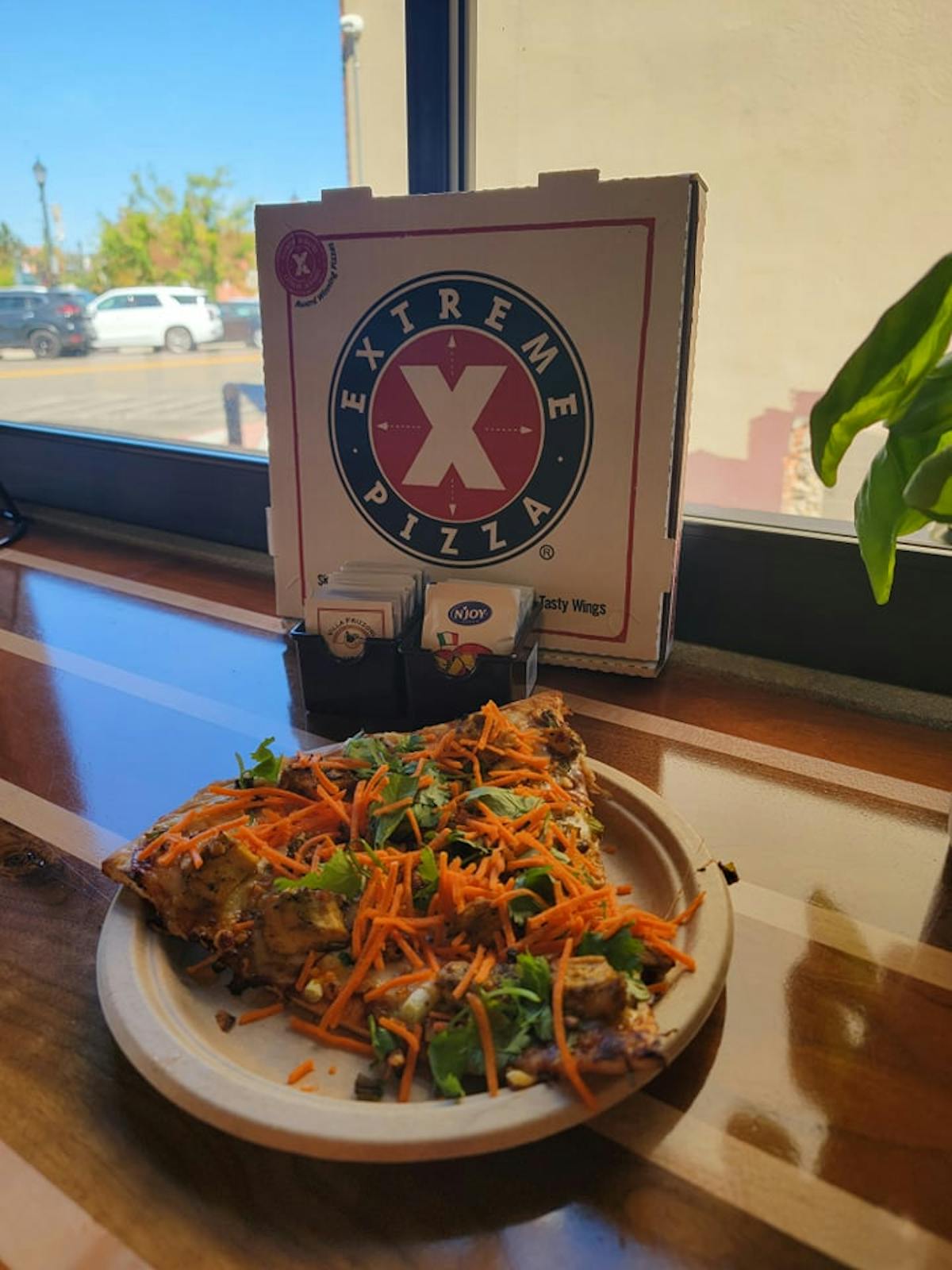 a pizza sitting on top of a wooden table