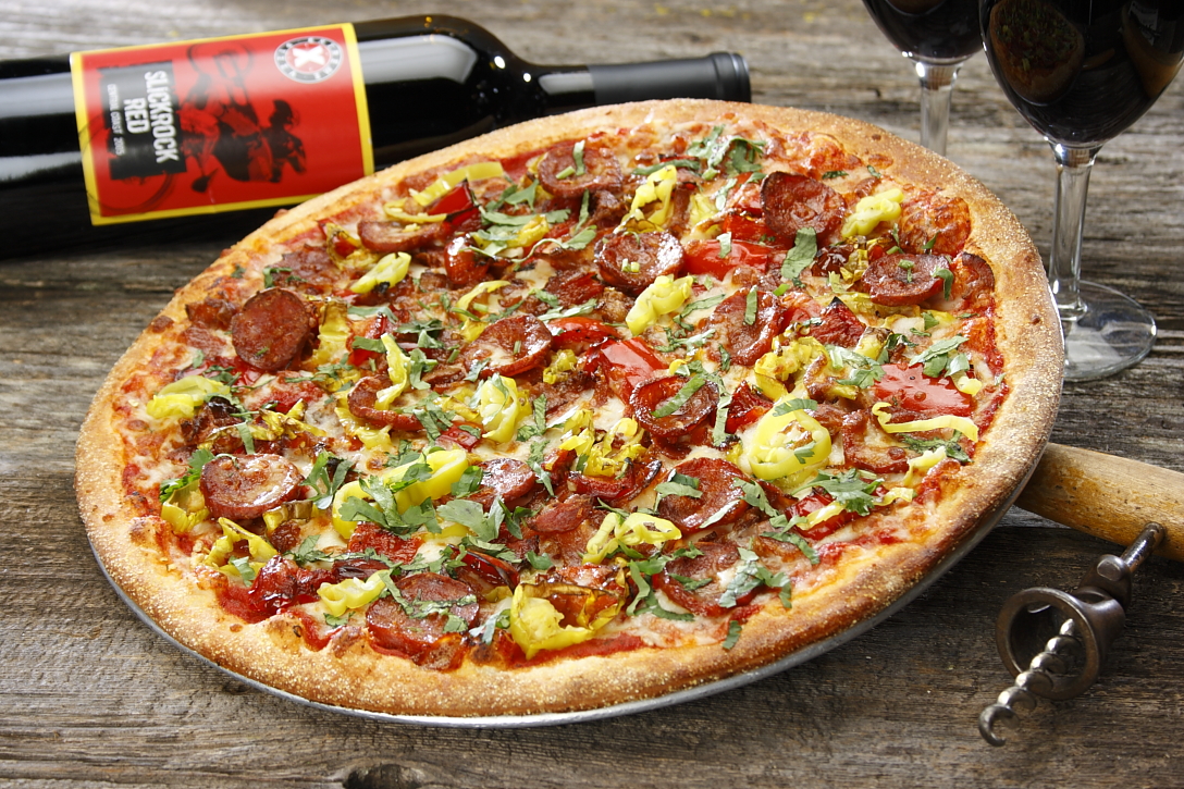 a pizza sitting on top of a wooden table