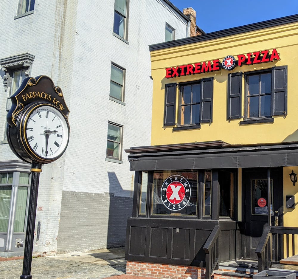 front of extreme pizza building with historic clock
