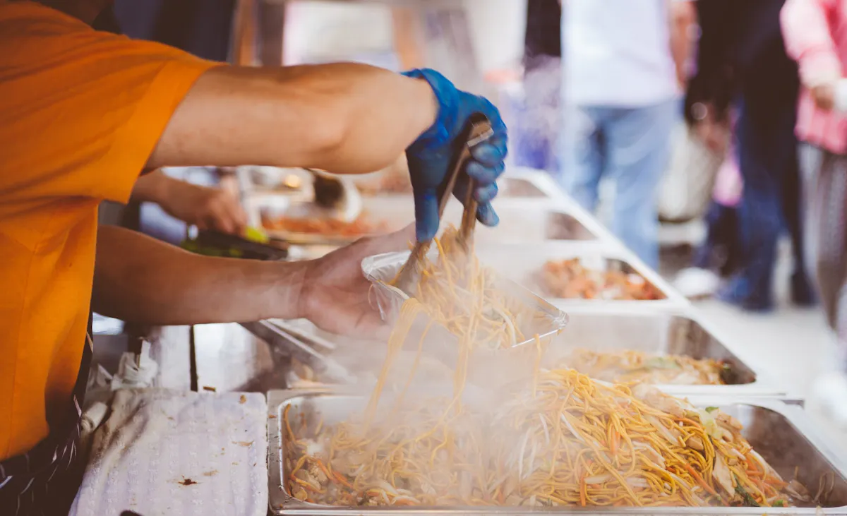 a person preparing food on a tray