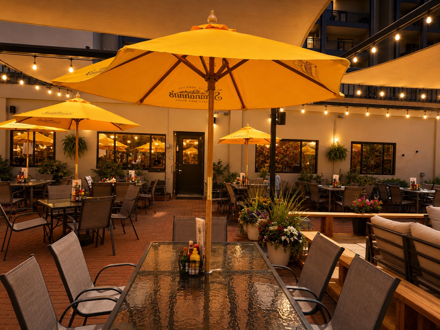 a patio with tables and chairs and umbrellas