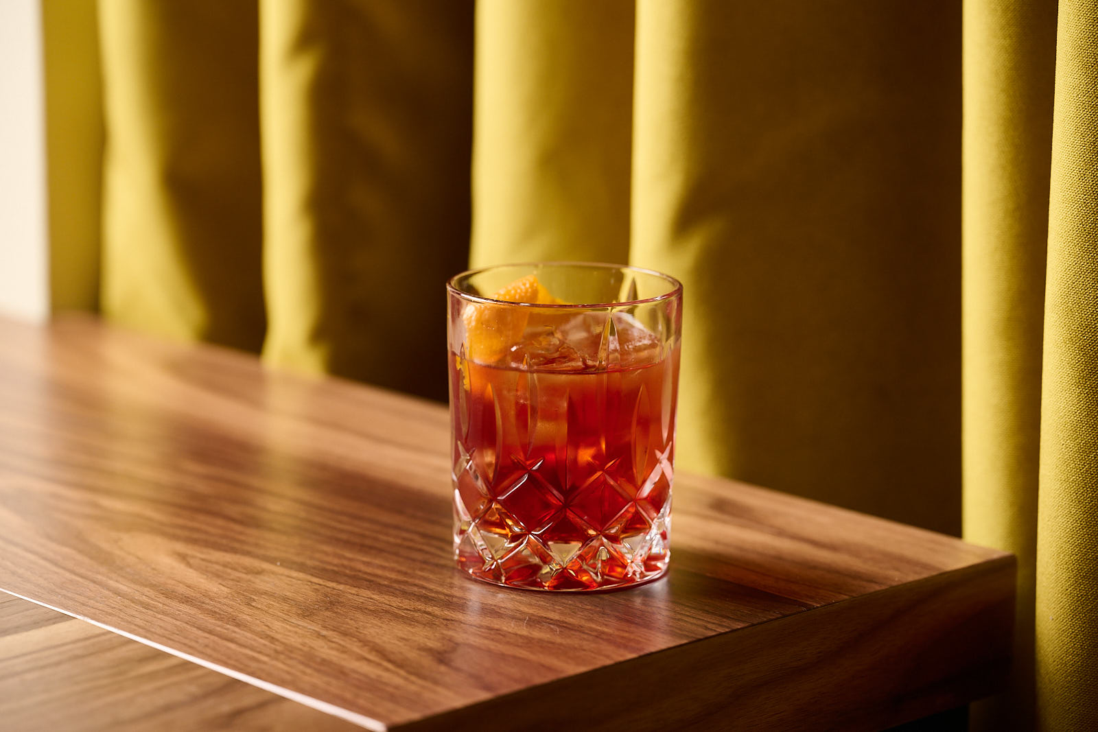 a glass of wine sitting on top of a wooden table