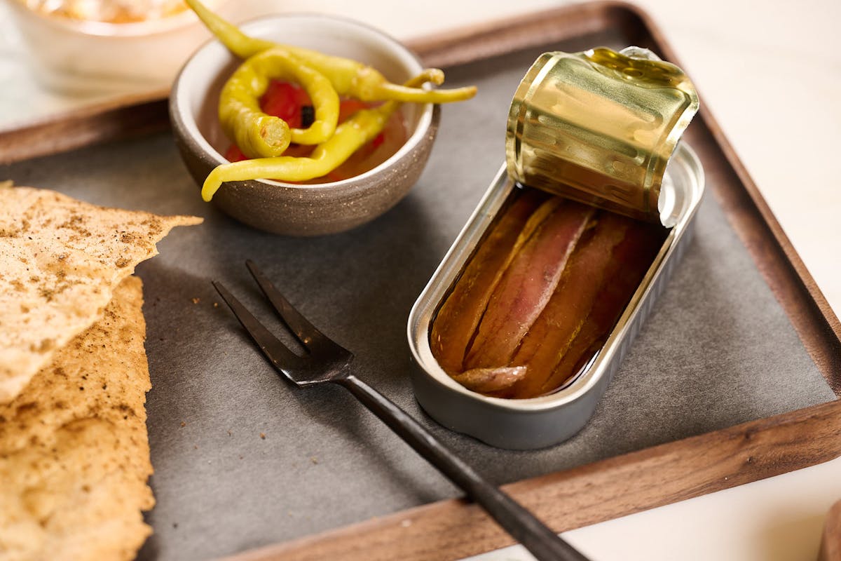 a bowl of food with a slice of bread