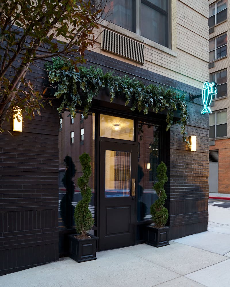 a bench in front of a brick building