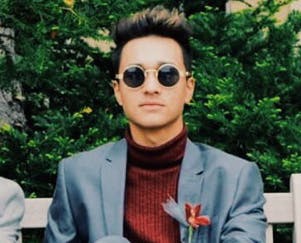 a man wearing sunglasses posing for the camera