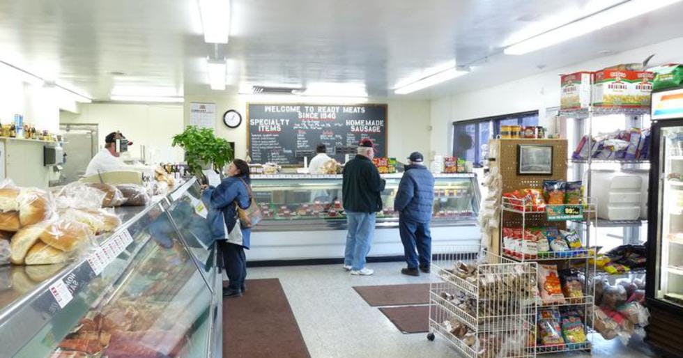 a person preparing food inside of a store