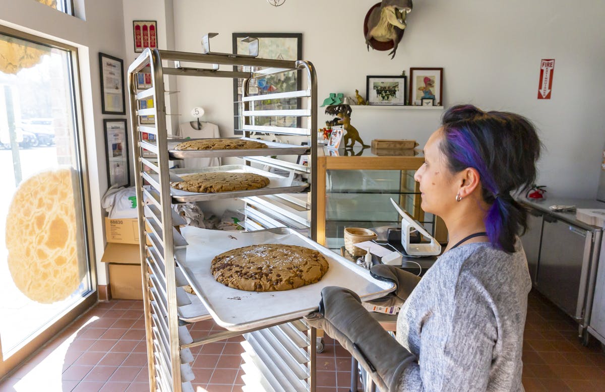 a woman cooking food in a kitchen