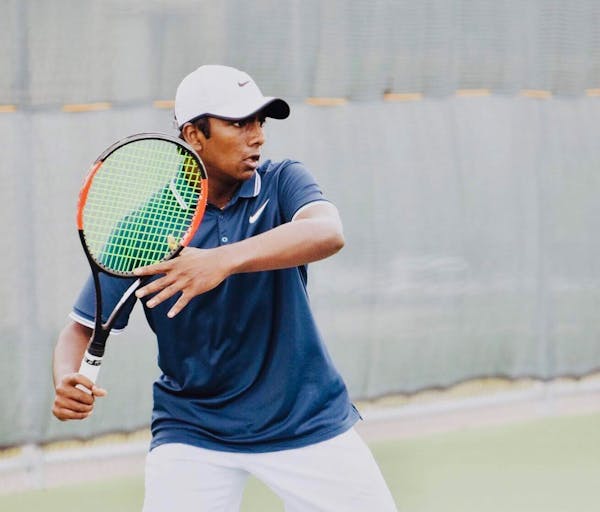 a man holding a racket on a court