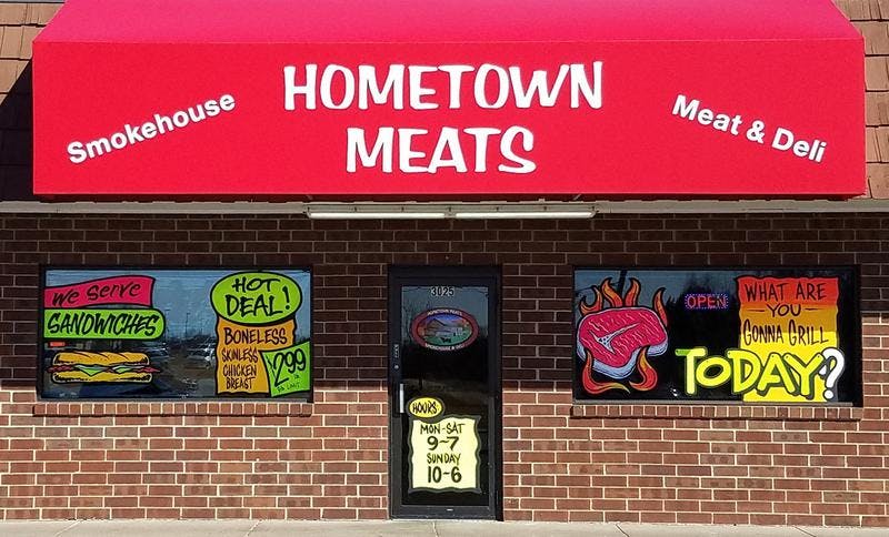 a sign above a store in a brick building