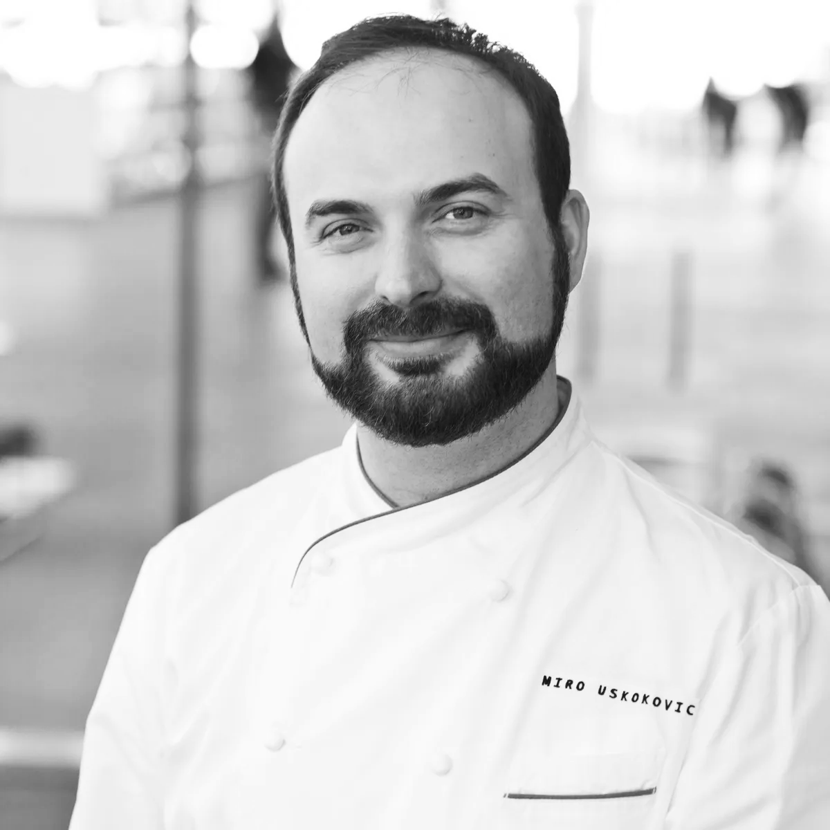 a man wearing glasses posing for the camera