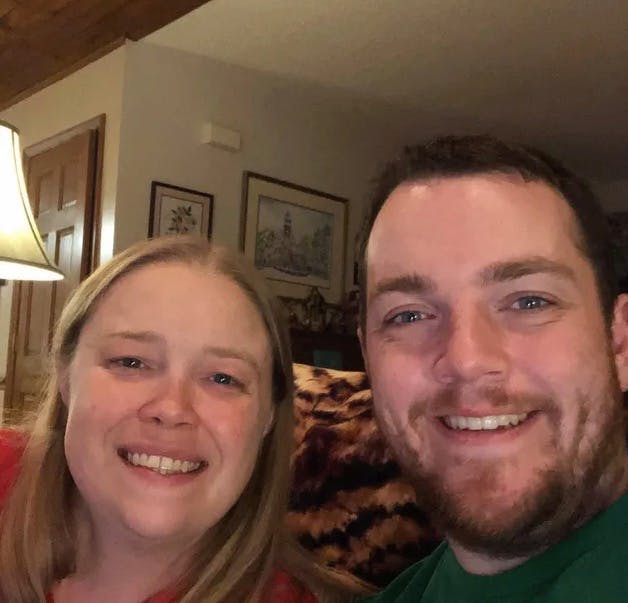 a smiling man and woman posing for the camera