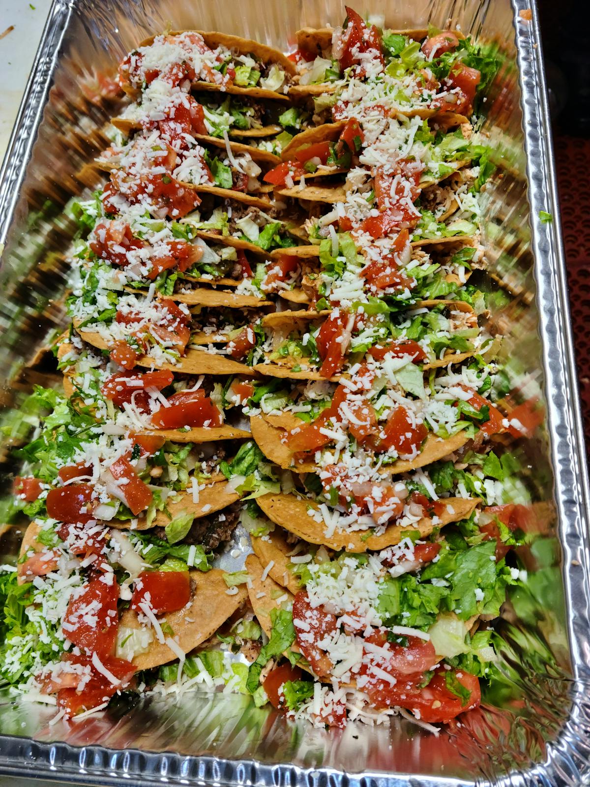 a tray of food with a slice of pizza