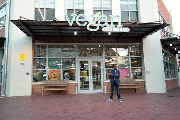 a person standing in front of a brick building