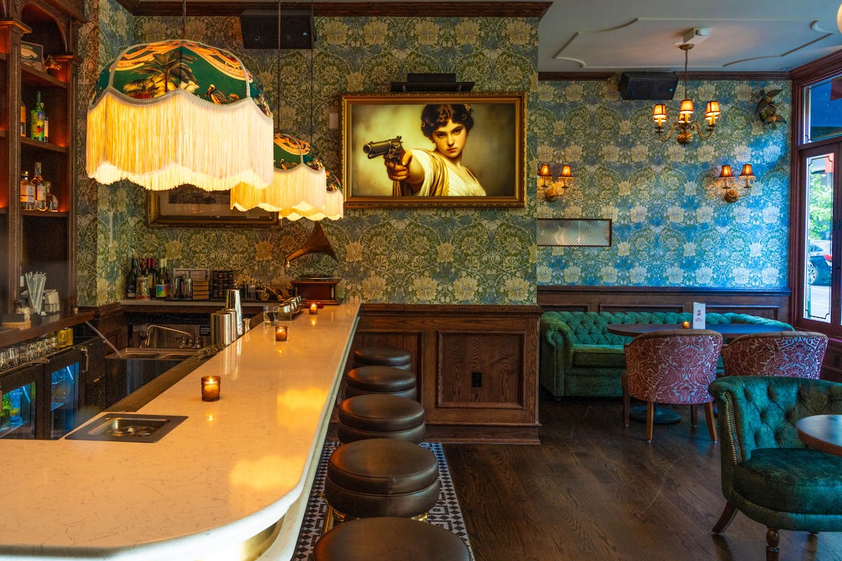 a chair sitting in front of a curtain