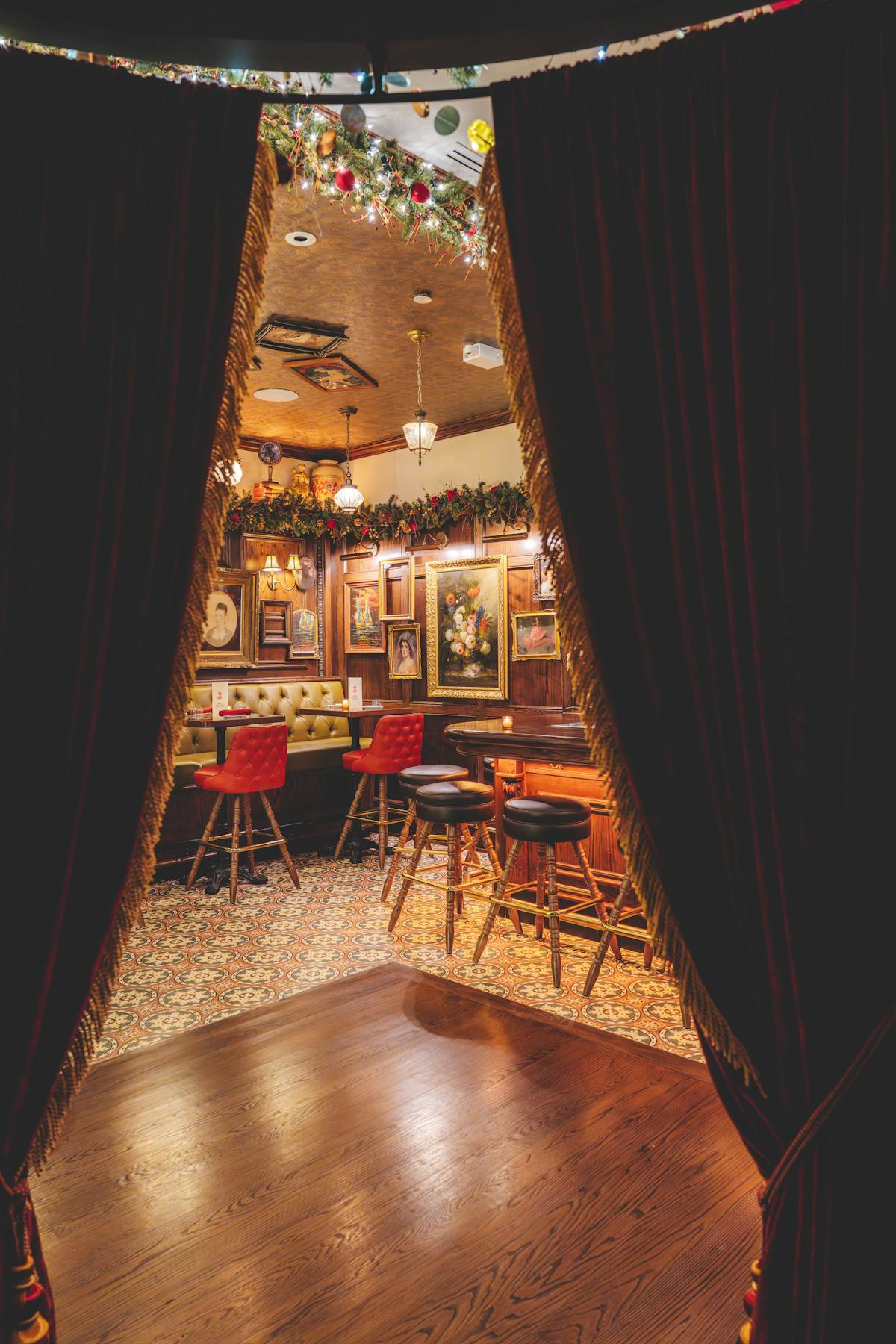 a chair sitting in front of a curtain