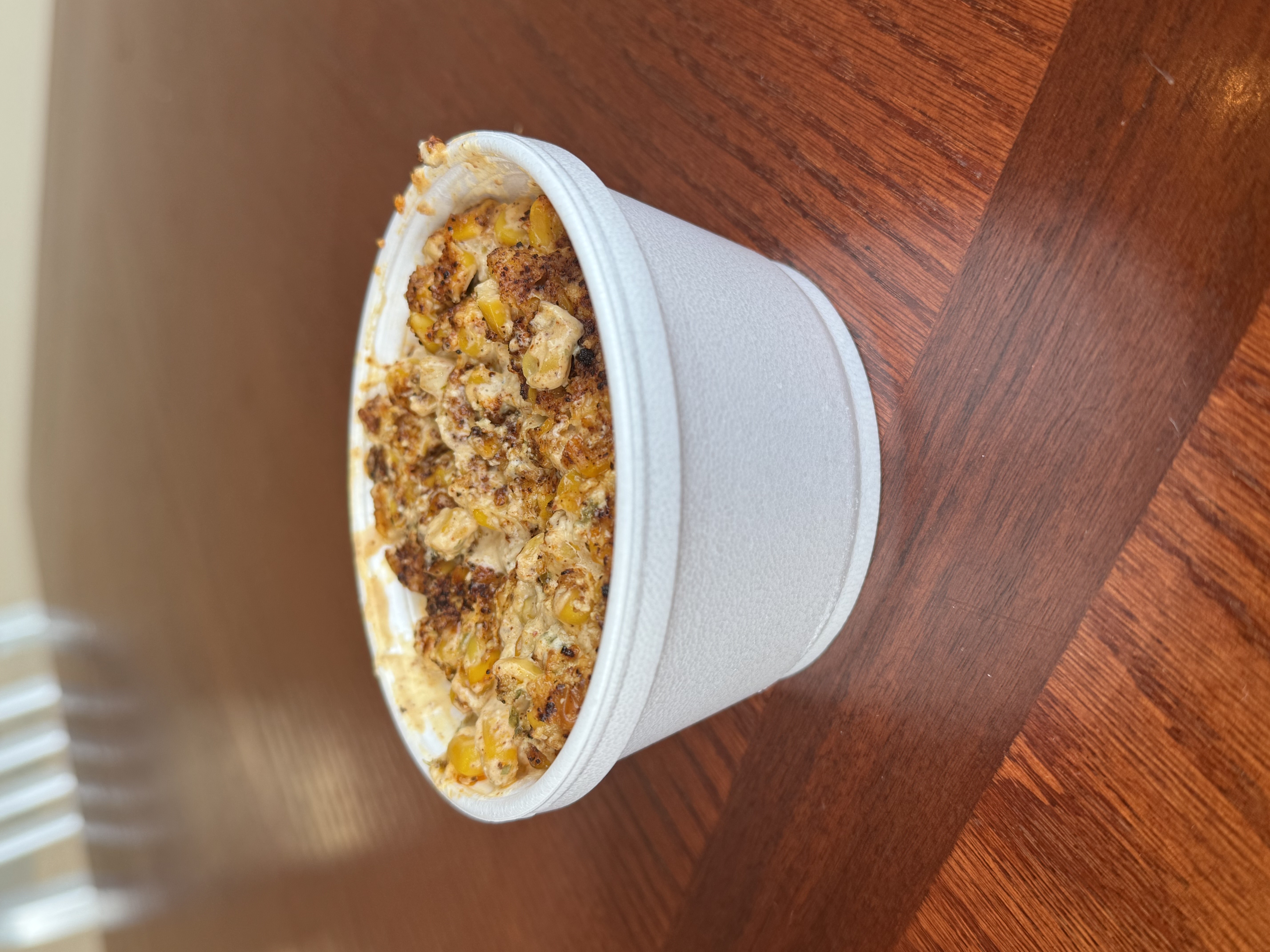 a bowl of food sitting on top of a wooden table