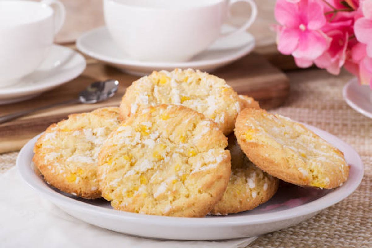 a plate of cookies with a coffee cup in the background