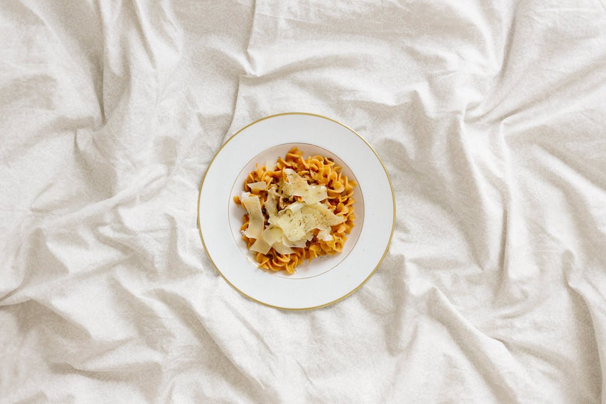a bowl or plate of pasta on a white tablecloth