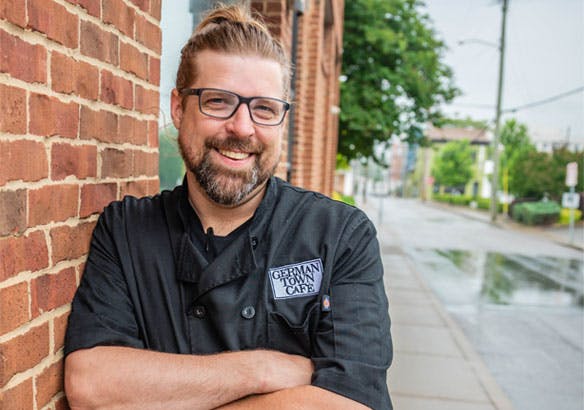 Chef Jeff Martin standing in front of the brick building of Germantown Cafe