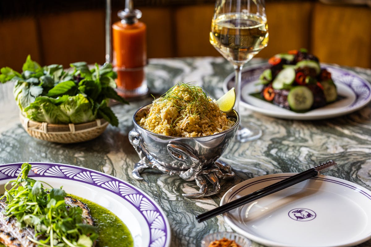 a plate of food and glasses of wine on a table
