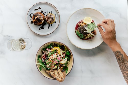 three fine plates with food