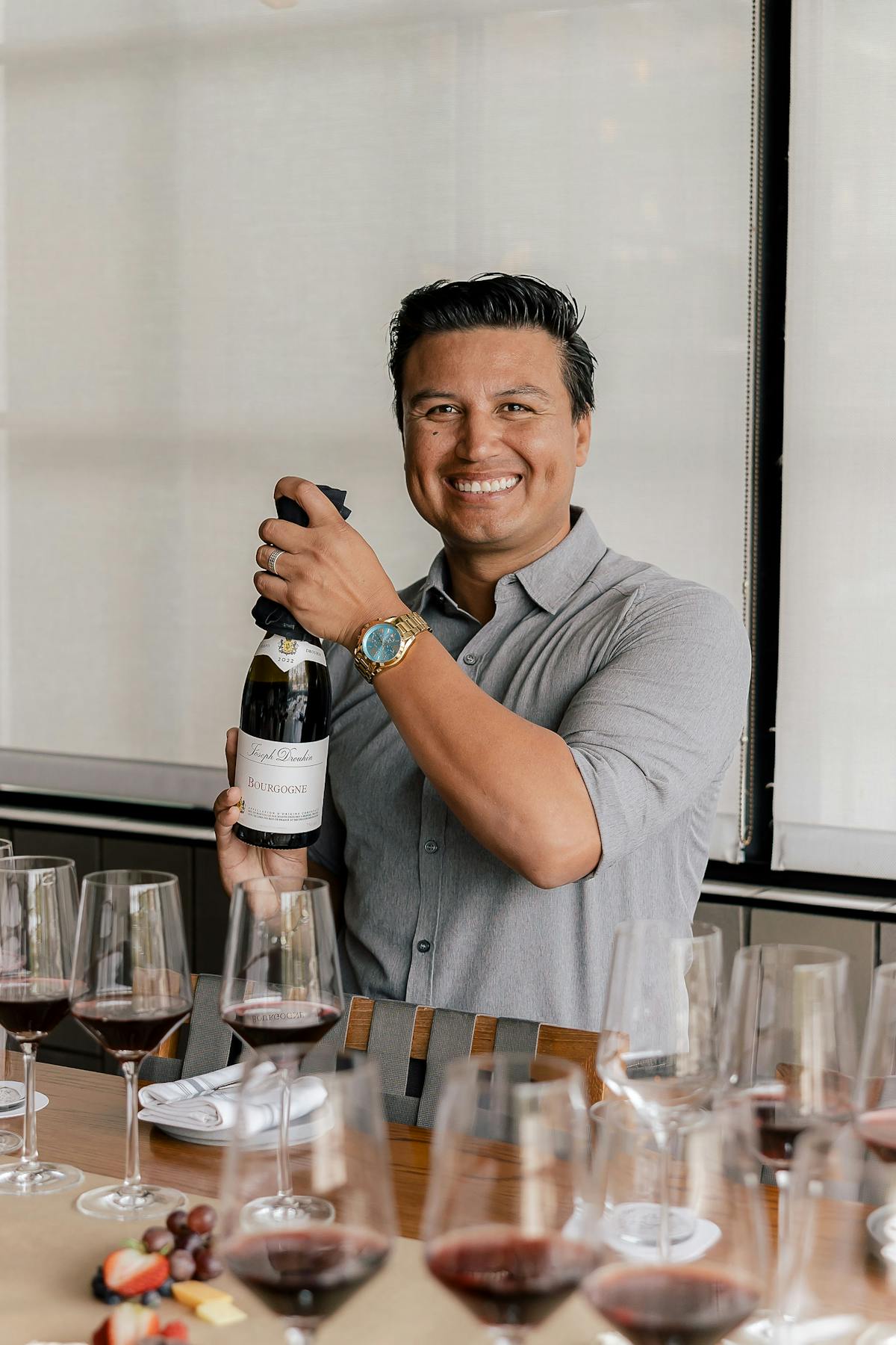 a man with a bottle of wine in his hands