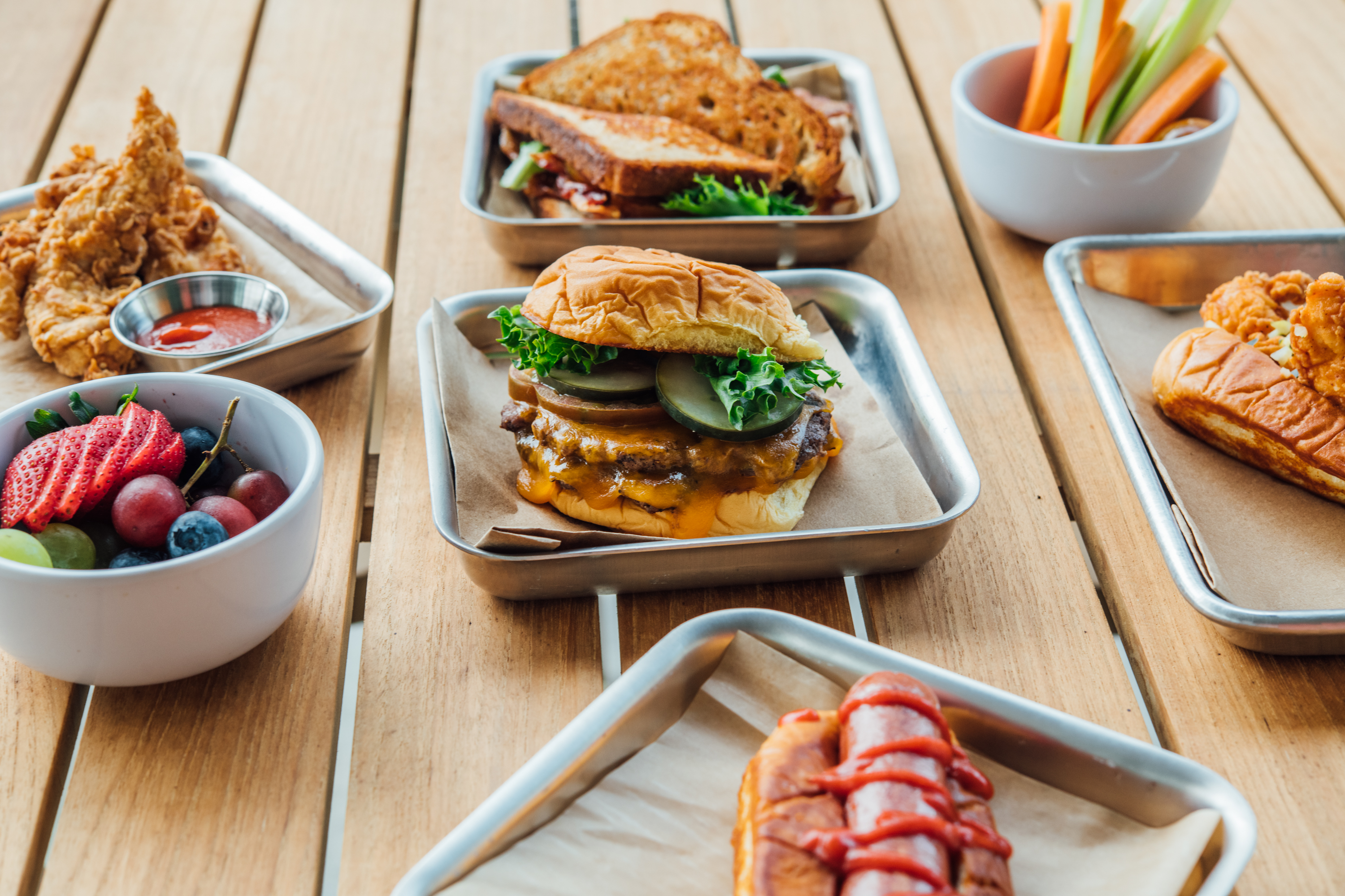 a bunch of food sitting on top of a wooden table