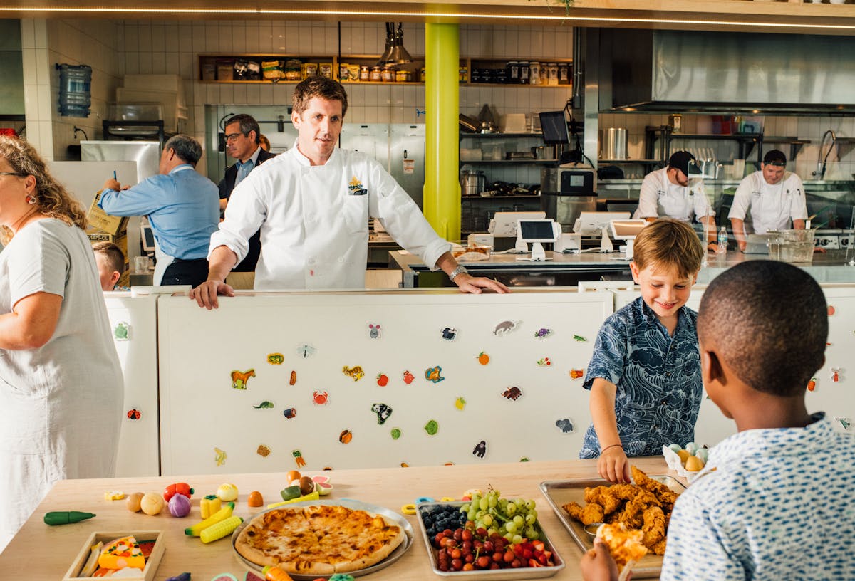 a group of people preparing food in a kitchen