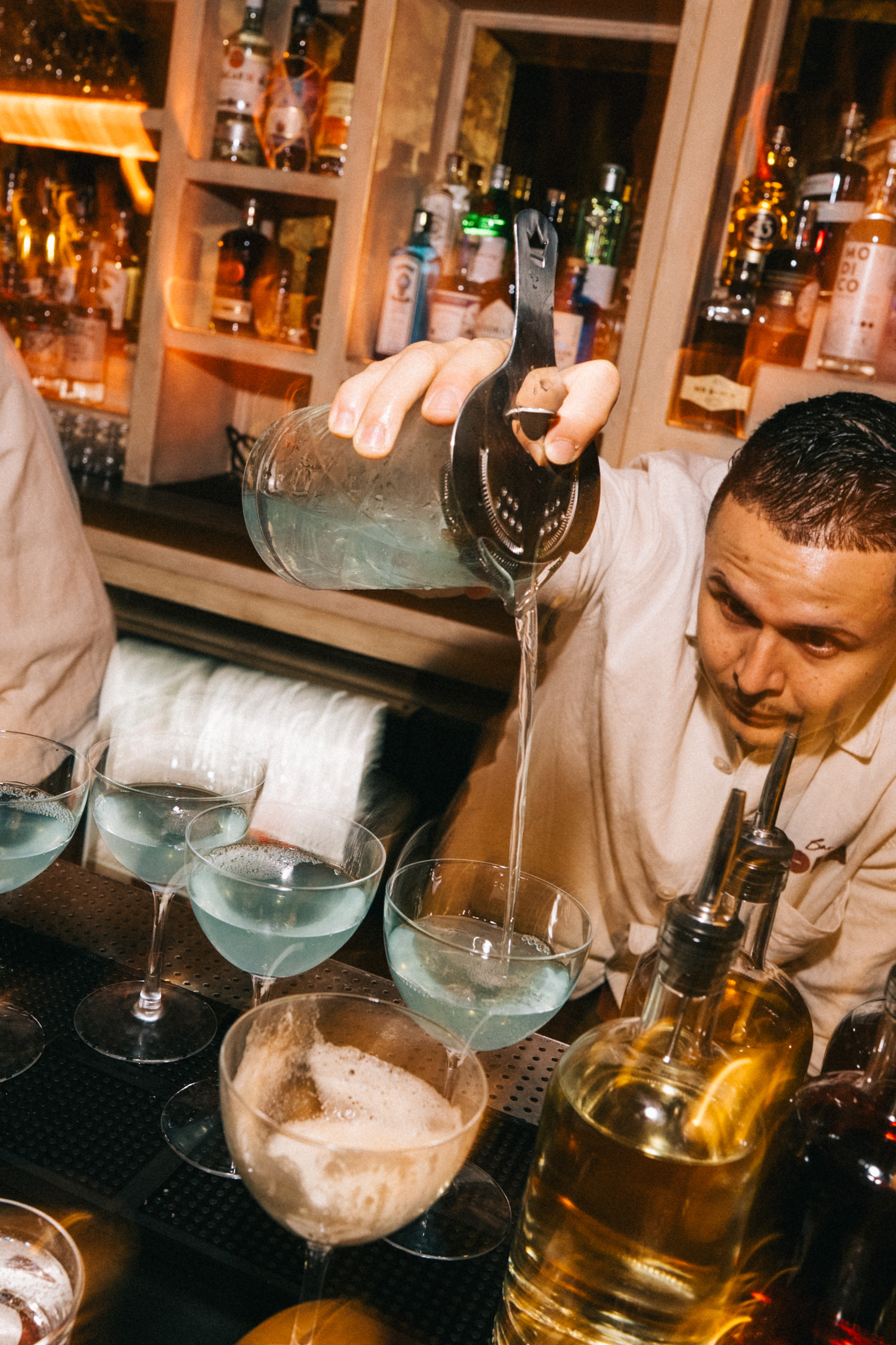 a bowl of olives and a martini glass with smoke
