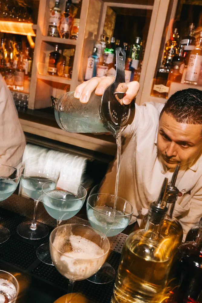 a bowl of olives and a martini glass with smoke