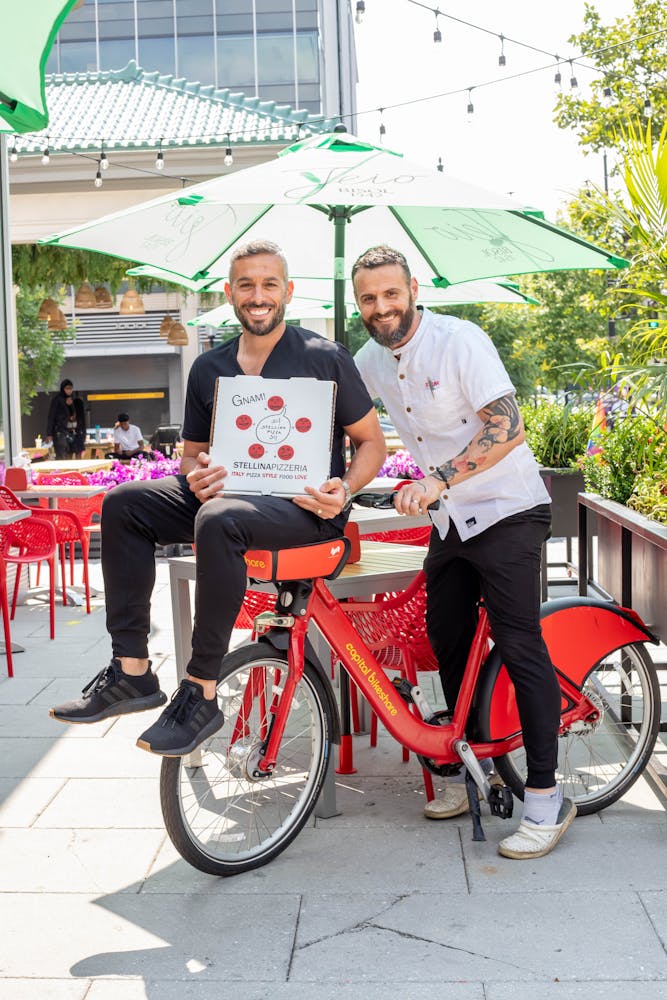 a man and a woman sitting on a bicycle