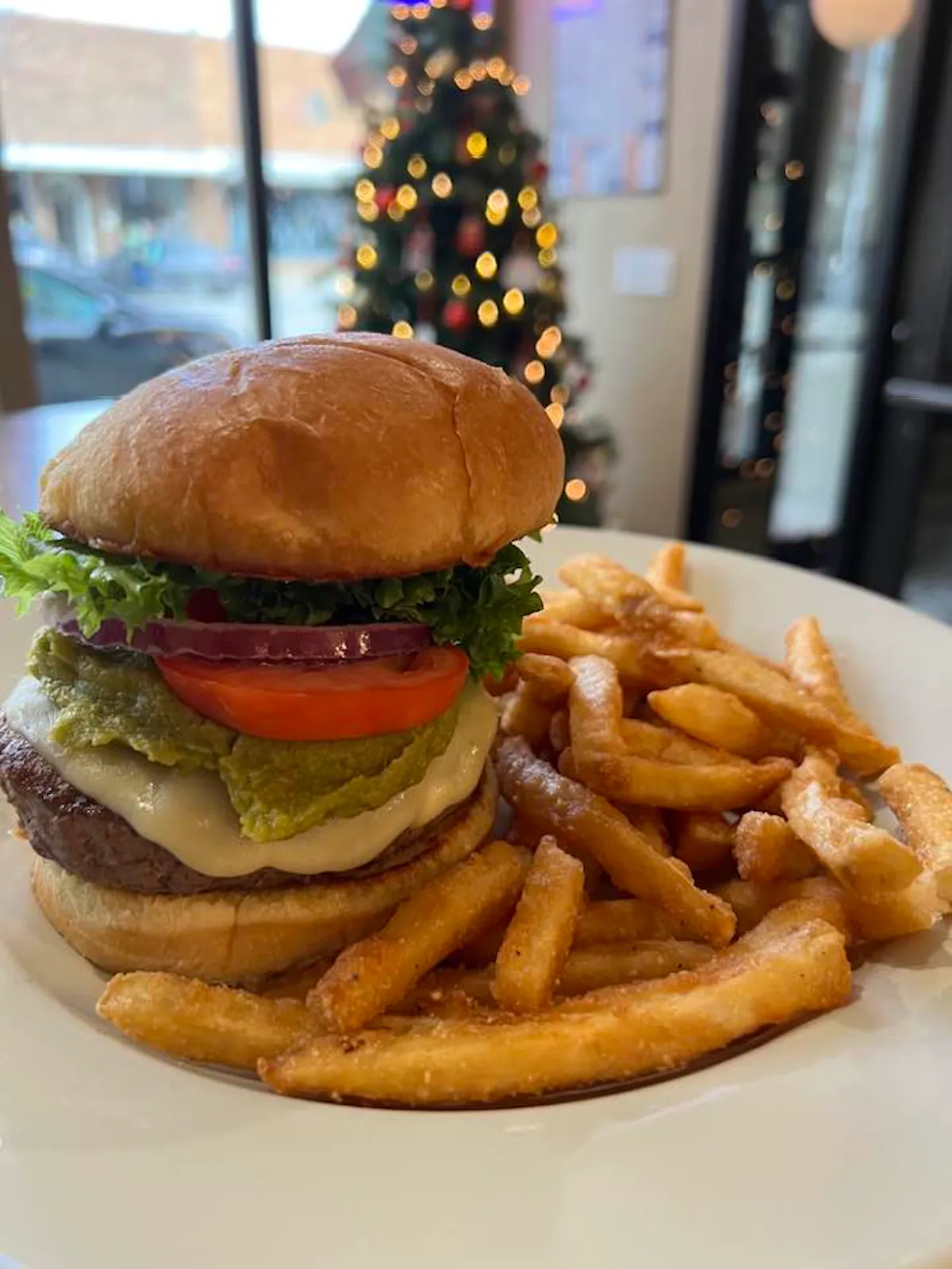 a close up of a sandwich and fries on a plate