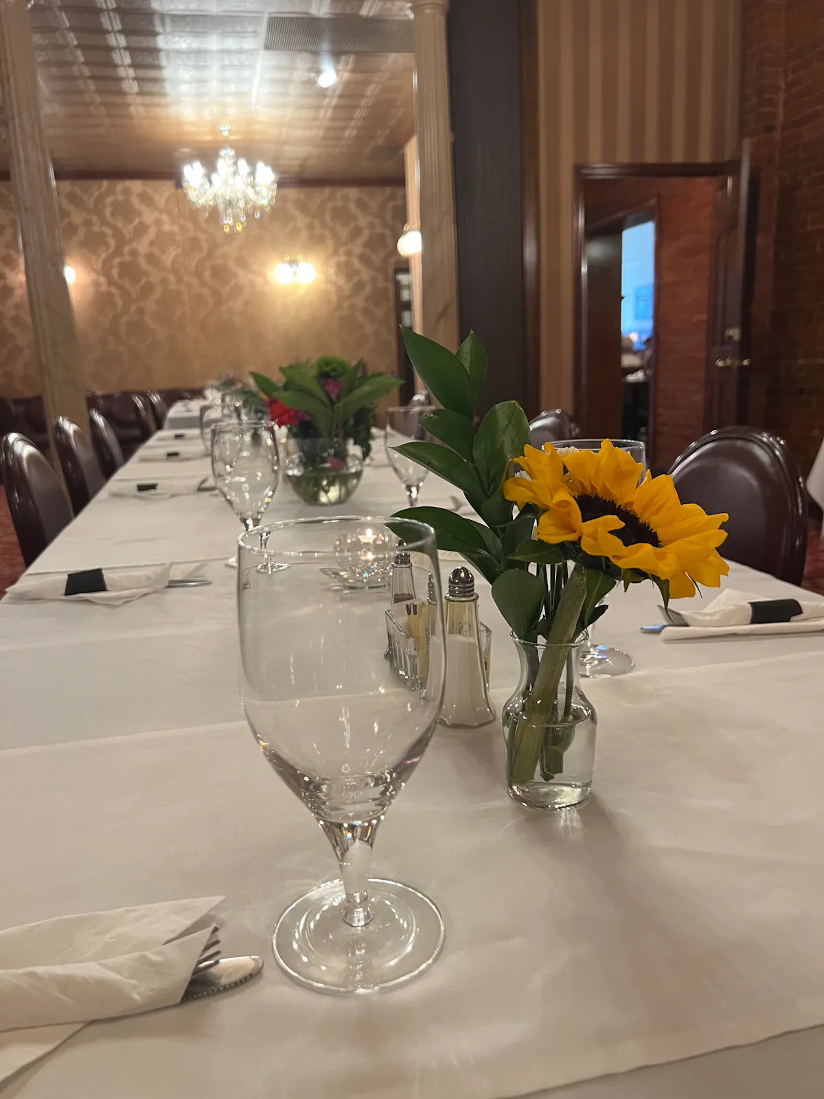 a group of people sitting at a table with wine glasses