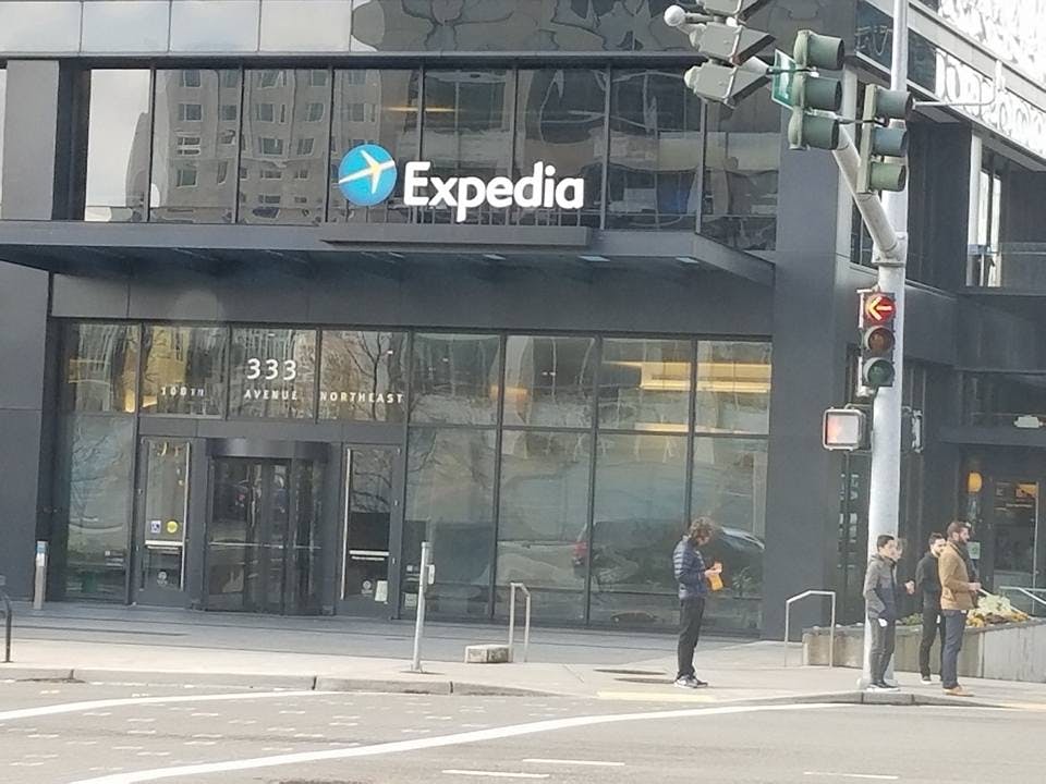 a group of people crossing a city street