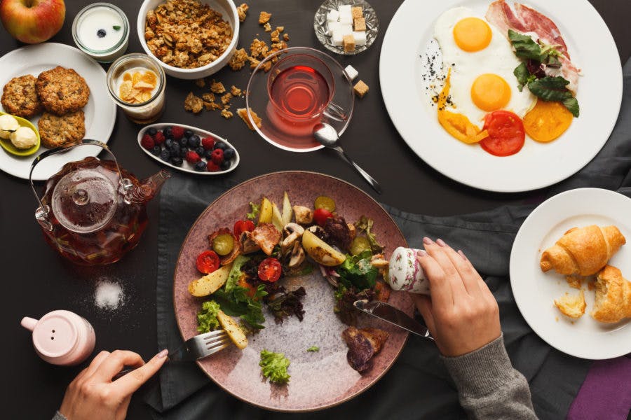 a group of people sitting at a table with a plate of food