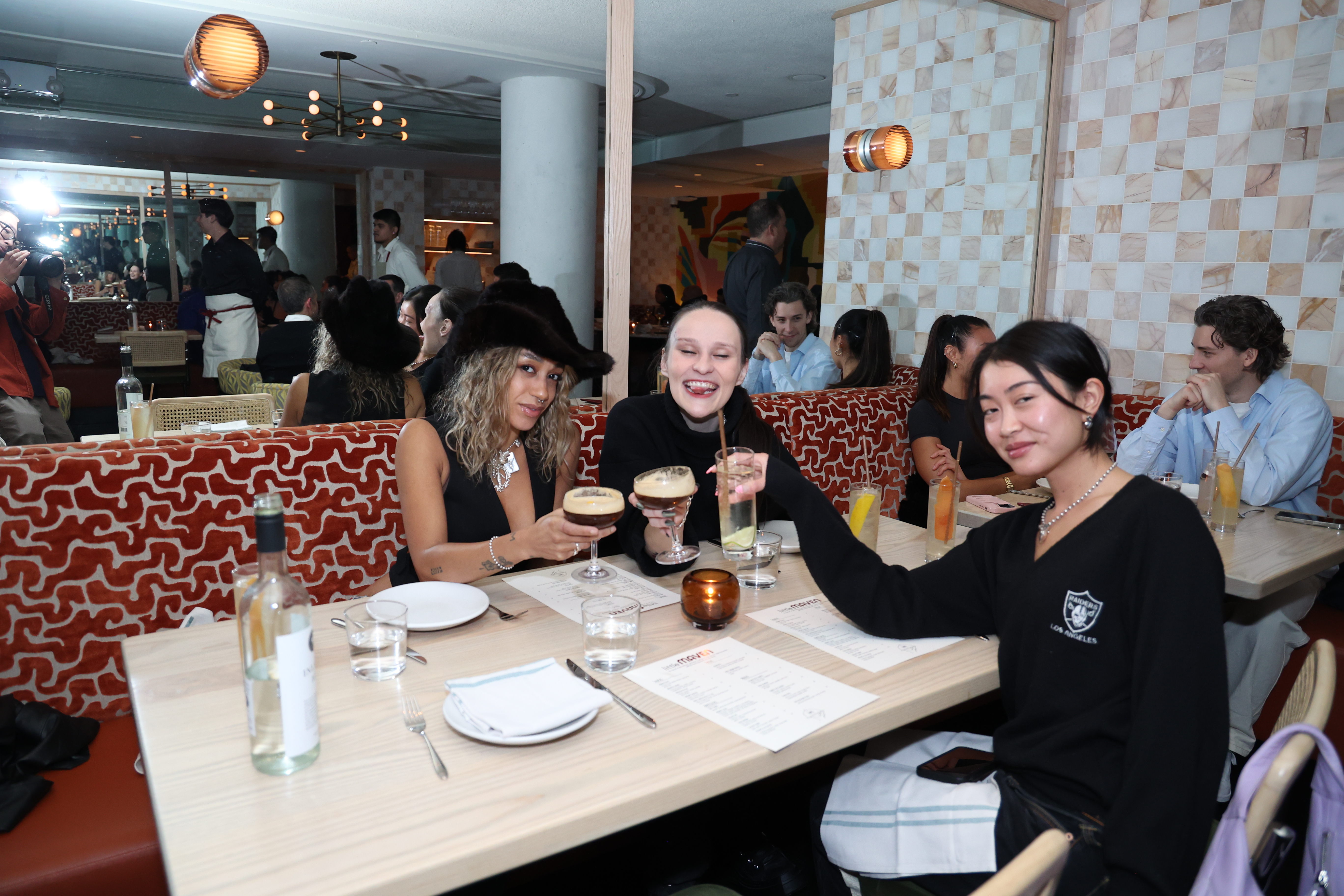 a group of people sitting at a table with wine glasses