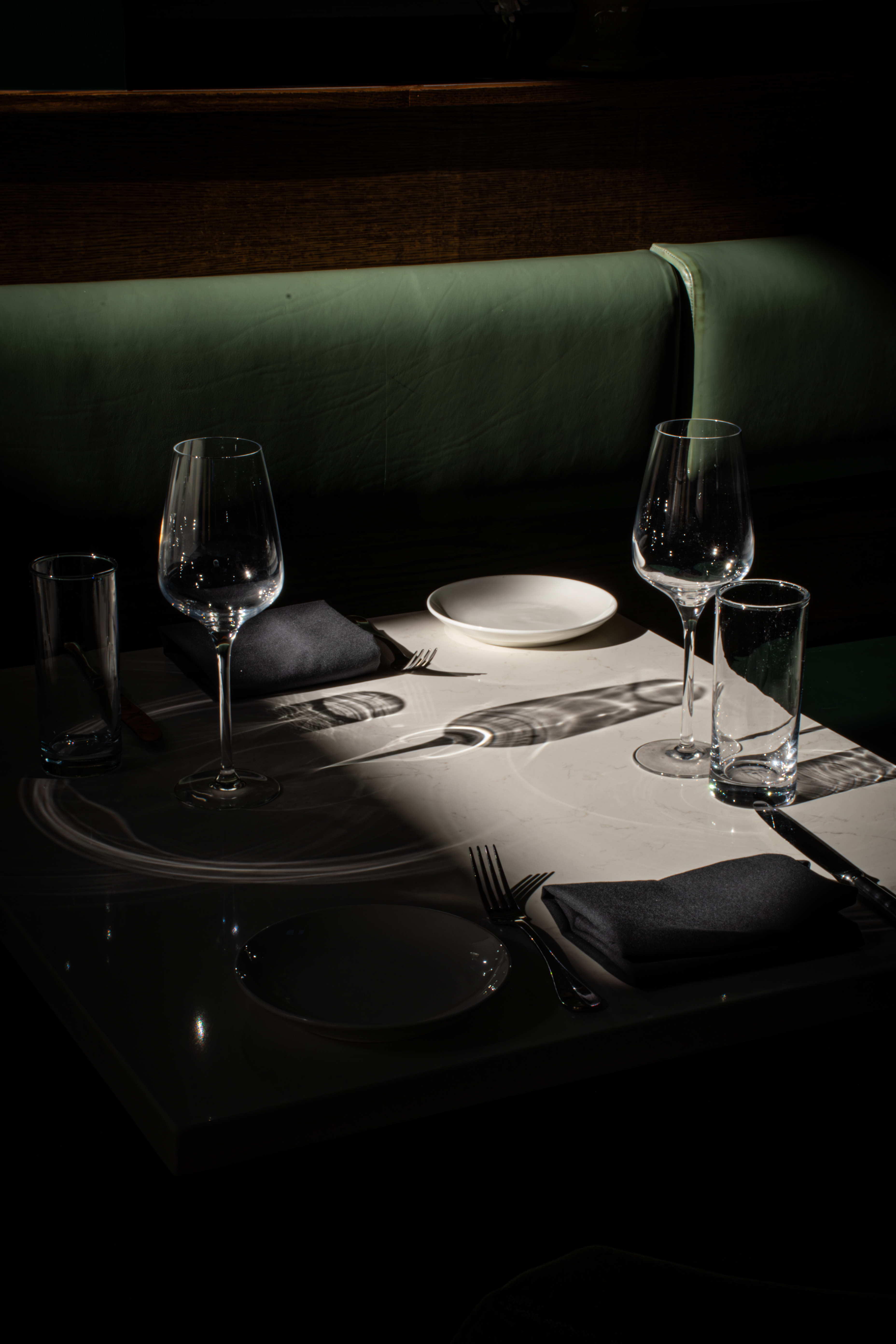 a glass of wine sitting on top of a table