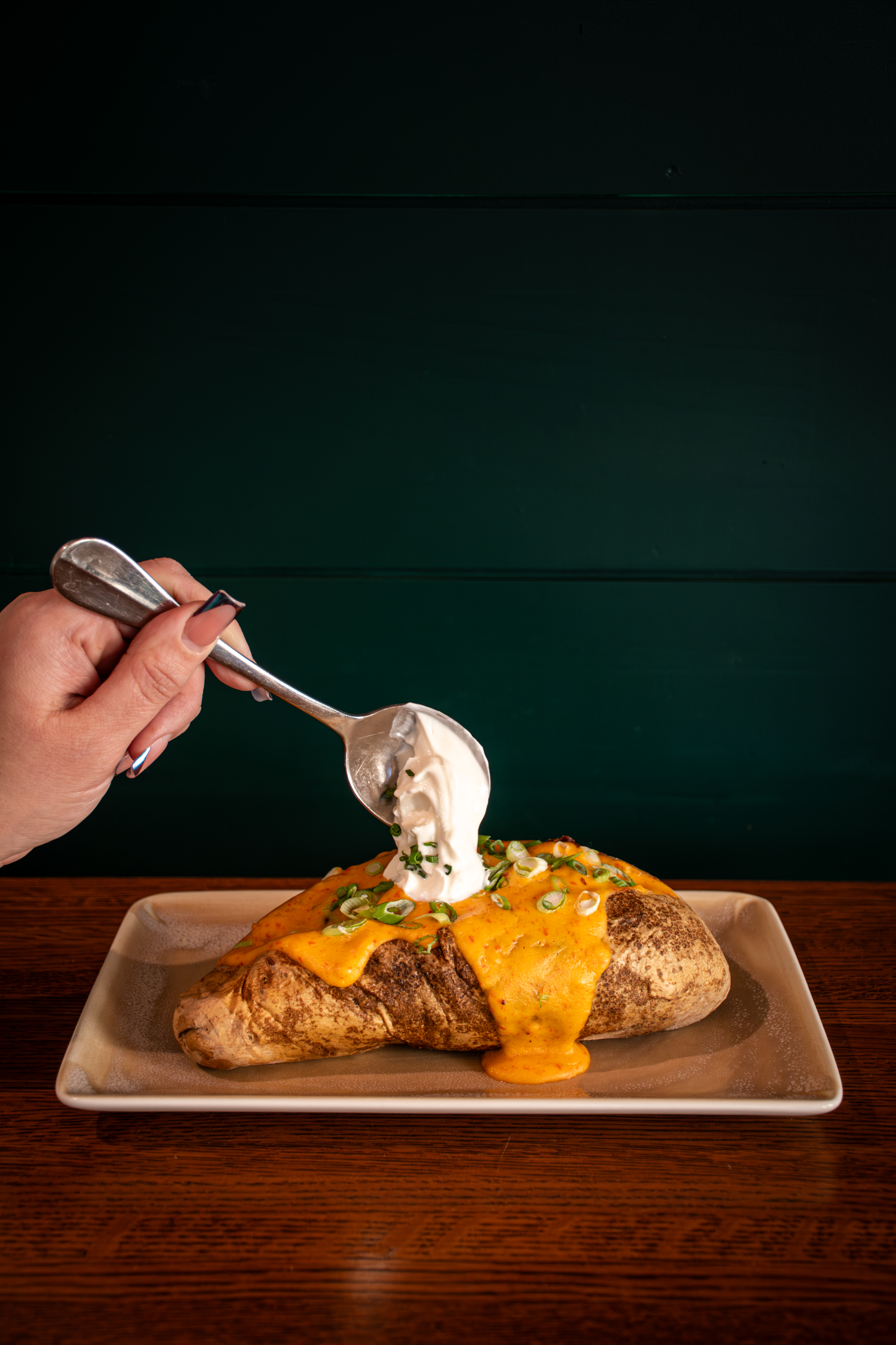 a person sitting at a table with a plate of food
