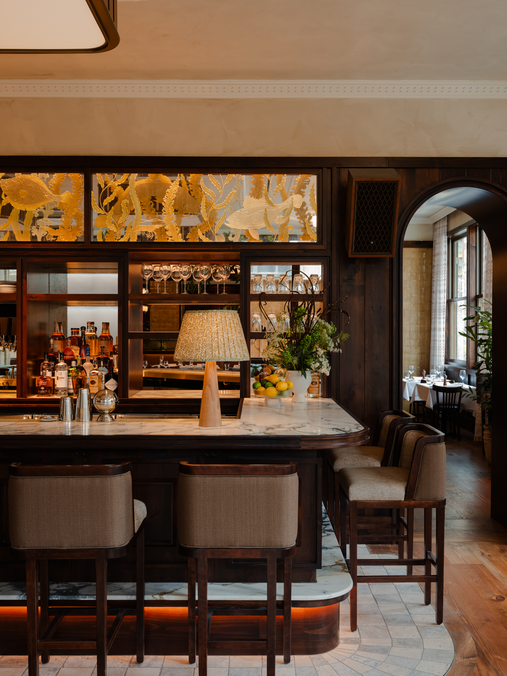 a room filled with furniture and vase of flowers on a table