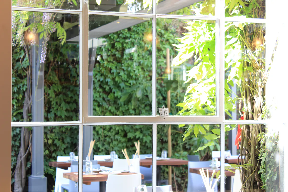 a group of people sitting at a table in front of a window
