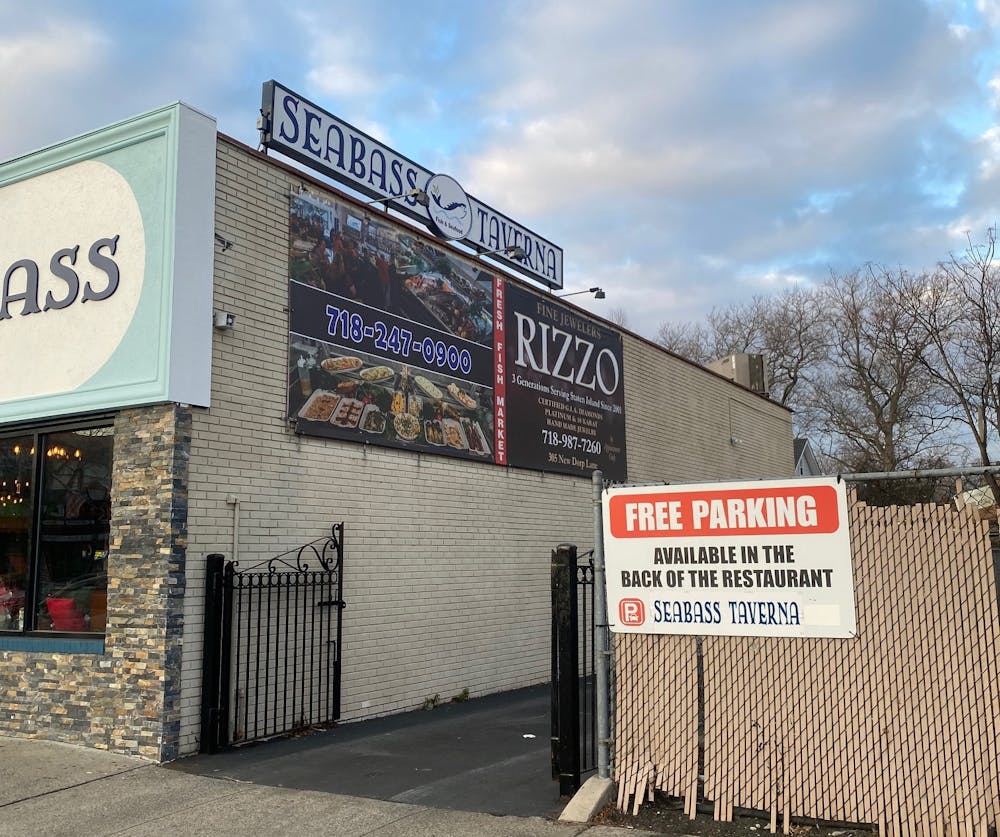 a sign on the side of a fence