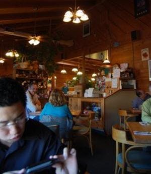 a group of people sitting at a table in a restaurant