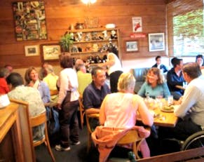 a group of people sitting at a table in a restaurant