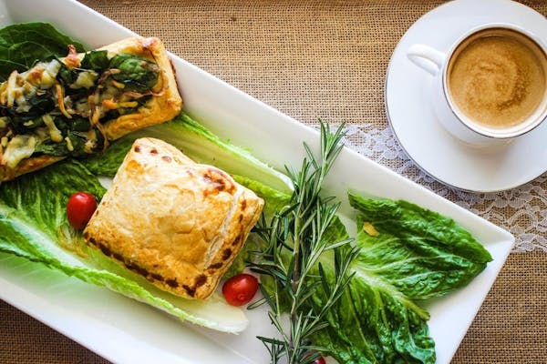 a plate of food and a cup of coffee