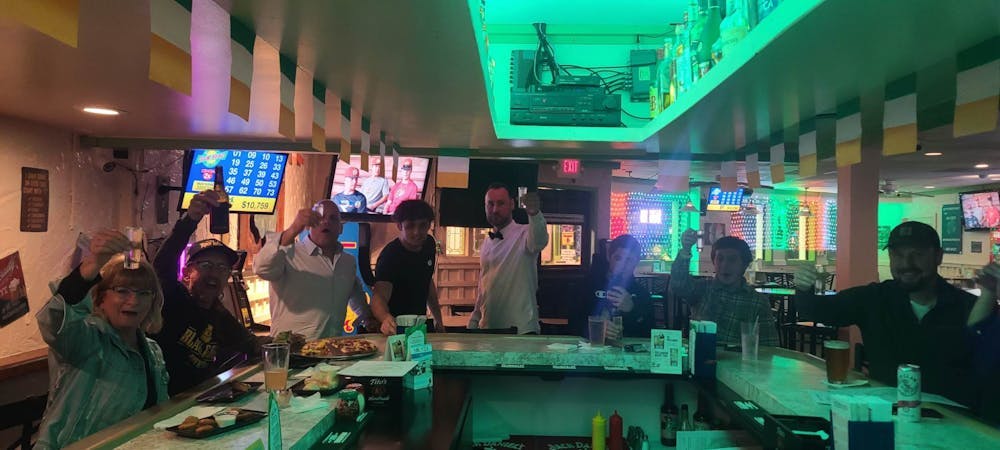 a group of people sitting at a table in front of a store