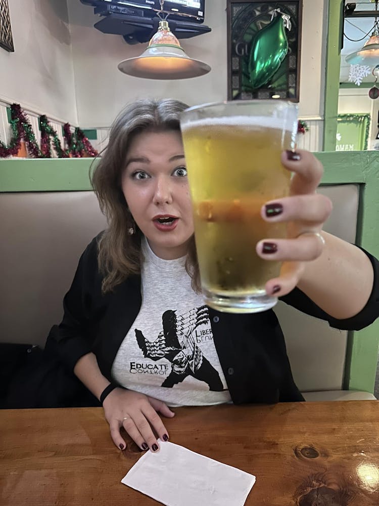 a woman sitting at a table with a cup of coffee