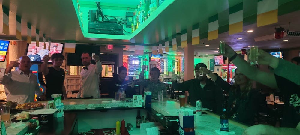 a group of people sitting at a table in front of a store